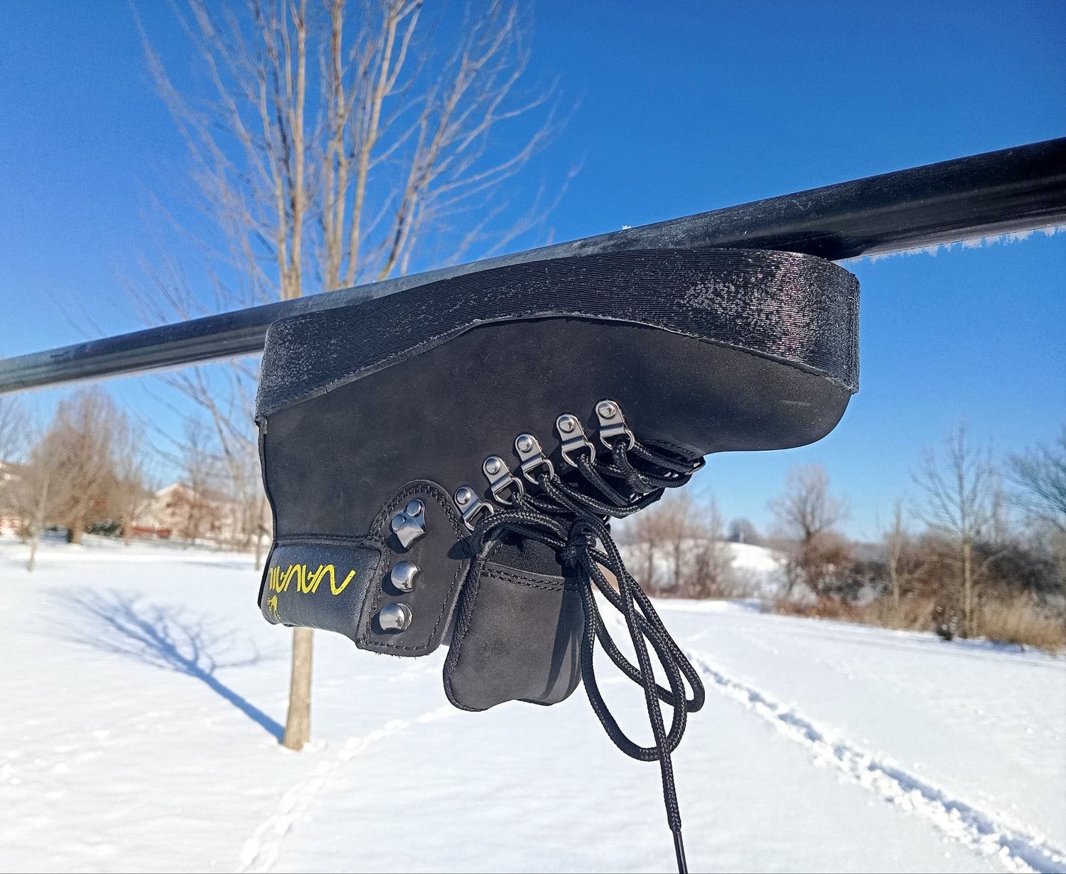 A magnetic boot is placed upside down under a round metal pole.