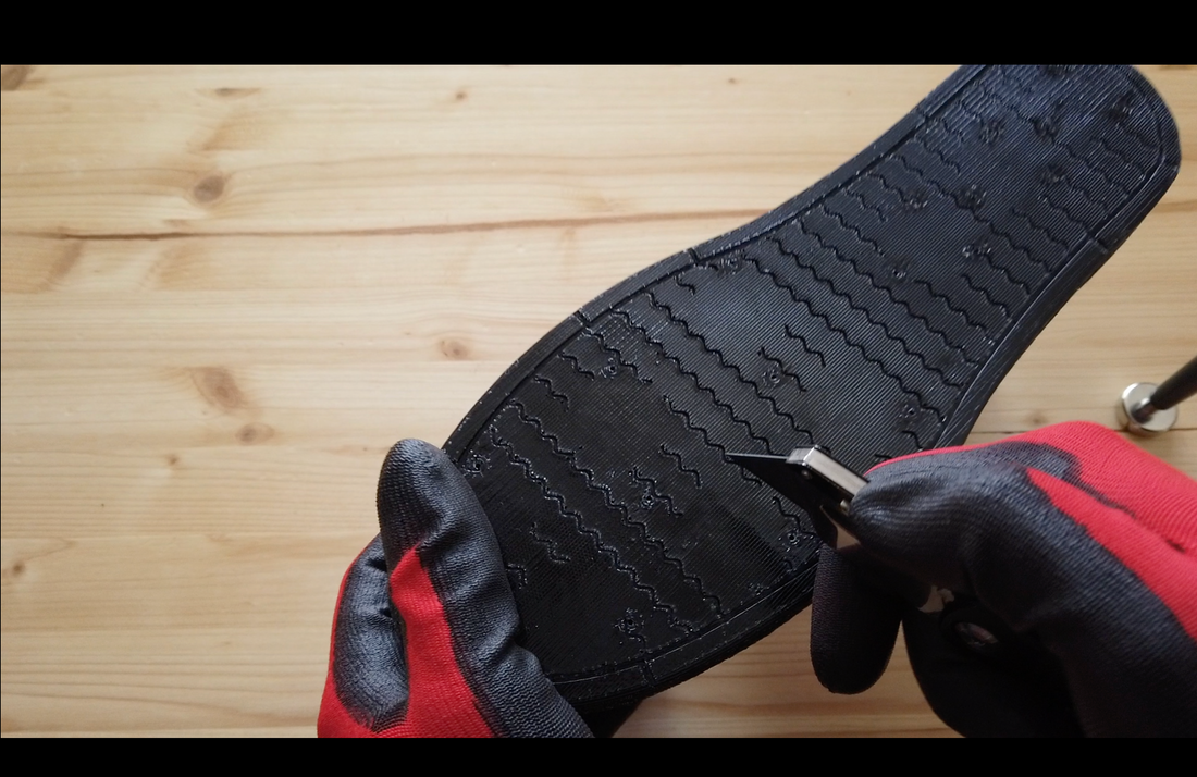 A Navail Magnetic boot is cut with a cutter all the way down to the magnet.
This test is done in order to prove the resistance of this shoe to puncture, cuts and other damage. 
Even with the sole cut all the way to the magnet, the magnetic shoe remains whole, sound and functional. No magnet is lost and the tear does not spread.
This innovative technology is patented. It is a game changer for roofer that operates on construction sites where debris and sharp objects can be found. Give an extra peace of mind.